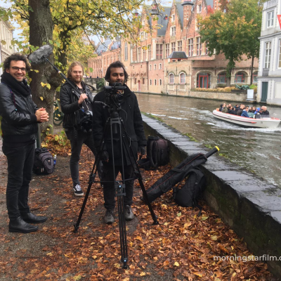 The Crew set up for a shot by a canal in Bruges
